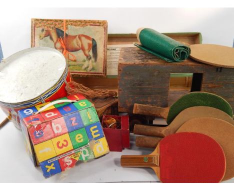 A vintage child's wooden pull-a-long train truck, tin drum, Cum-Bak tennis trainer, table tennis bats, The Abbey tennis ball 