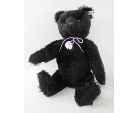 A Steiff black growler teddy bear, 43cm long.