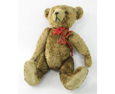 A hump back teddy bear, with long snout, arms and legs, and button eyes, 40cm long.