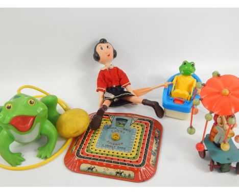 A collection of tin plate and other toys, including a Lucky Spinner horse race game, Jumping Frog, Olive Oyl doll and a clock