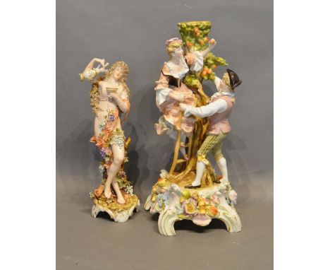 A German Porcelain Candlestick with figural surmount, together with a similar Naples figure, 32cm and 26cm tall 