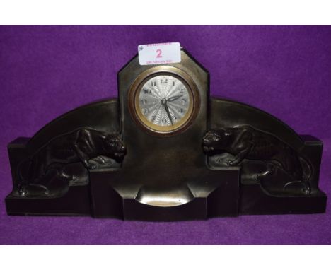 An art deco bronzed mantel clock having silver dial of stepped design with wild cats / Jaguars to either side also having whi