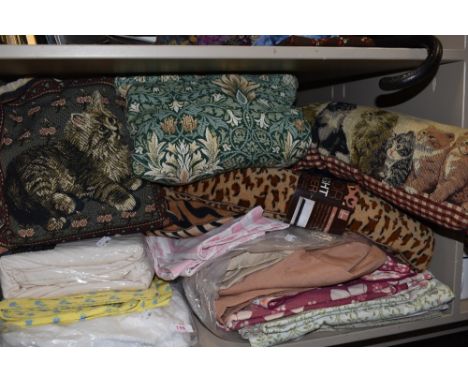 A mixed lot of retro and modern bedding and textiles including draught excluders and cushions.