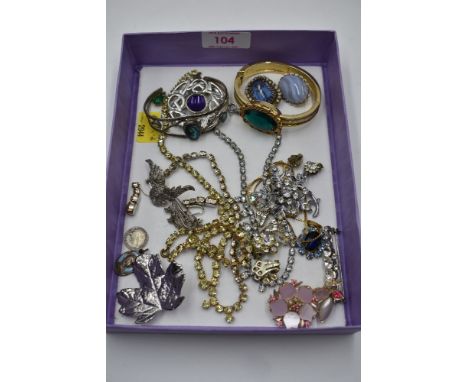 A selection of costume jewellery including diamante, bangle watch, brooches, religious charm etc