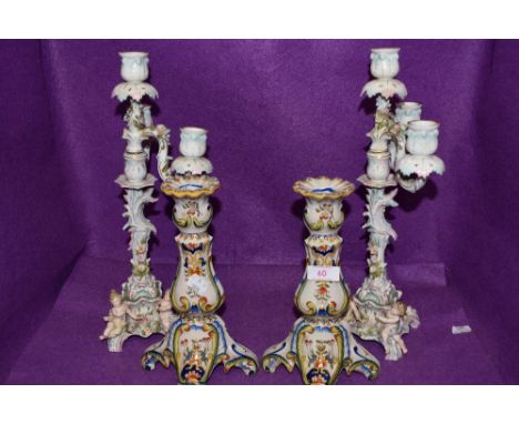 Two vintage ceramic candle sticks having cherubs to base and floral decoration AF, also included are a pair of Portuguese or 