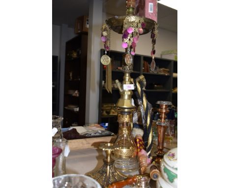 A large brass and glass shisha pipe.