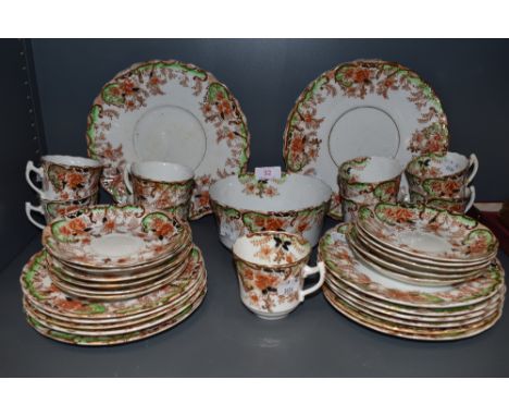 An antique part tea service by Sutherland china having green and red colour way