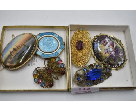 A small selection of vintage costume jewellery brooches including ceramic scenes and a St Christopher enamelled panel stamped