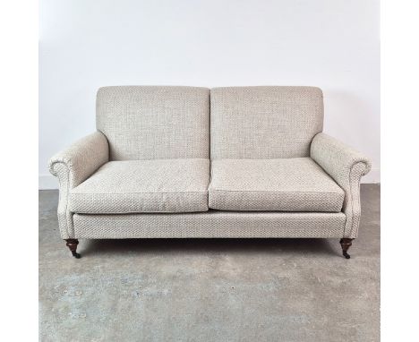 SOFA. traditional style, in a woven fabric on turned supports on castors approx 99cm d x 175 cm w x 86cm t.