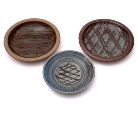*John Leach [1939-2021] Muchelney Pottery three stoneware dishes: each of circular form and under wood ash, tenmoku or pale b