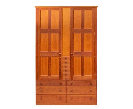 Conran, a contemporary cherrywood compactum wardrobe,: the cornice above twin panel doors flanking a blind panel, above five 