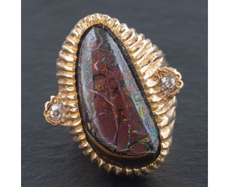 A cabochon-cut boulder opal and diamond ring,: estimated dimensions of boulder opal ca. 2.9x1.3cm, estimated total diamond we
