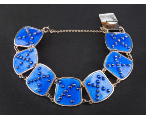 K A Rasmussen, Oslo, Norway, a silver and blue enamel bracelet,: plaques with applied beaded abstract pattern to textured blu