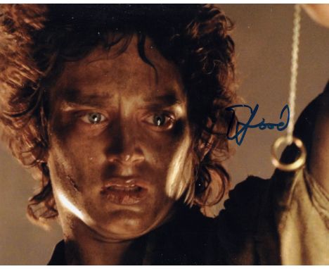 Lord of the Rings 8x10 movie photo signed by actor Elijah Wood as Frodo Baggins. Good condition. All autographs come with a C