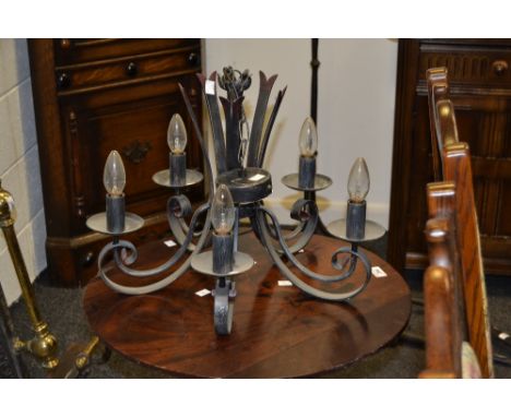 A contemporary cast iron five light chandelier