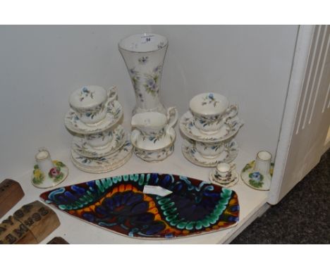 A Poole Delphis navette shaped dish in tones of blue , green, orange and red; a set of four Royal Albert Brigadoon pattern te
