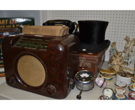 A silk Top Hat ; a pair of goggles; a Smiths clock, another from a motor vehicle; a Bush bakelite radio; a small leather suit
