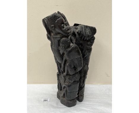 An African ebony wood carving of multiple figures around a tree. 15' high