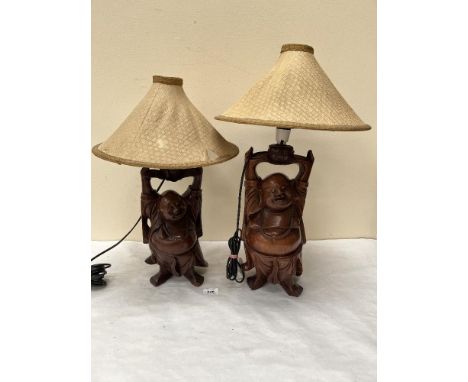 Two Japanese carved hardwood figural table lamps. The figures 12½' and 14' high. One shade A.F.