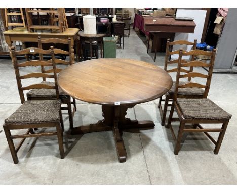 A set of four Ercol ladderback chairs with an extending dining table