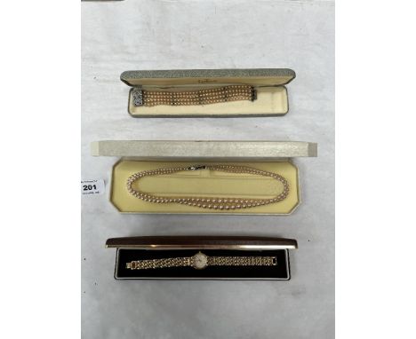 A Rotary lady's plated wristwatch, a boxed Lotus simulated pearl necklace and boxed bracelet