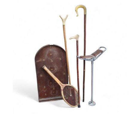 A bagatelle board;&nbsp; a tennis racket;&nbsp; shooting stick;&nbsp; walking sticks 