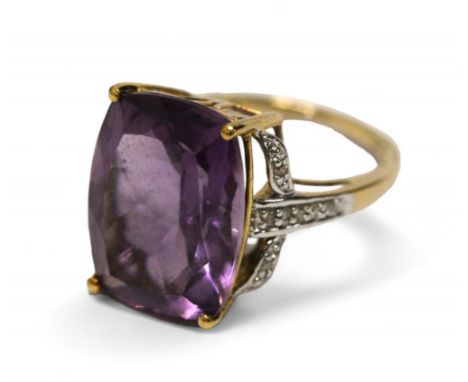 A 9ct gold, amethyst and diamond chip cocktail ring, the four claw set rounded emerald cut amethyst measuring 16 x 12mm, the 
