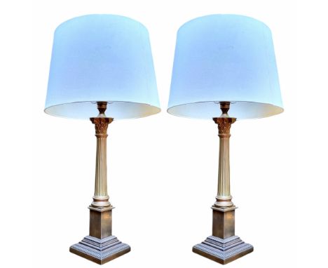 Lighting - a pair of brass Corinthian column table lamps 67cm with shades 