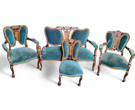 A late 19th century Art Nouveau salon suite, comprising sofa, two side chairs and a nursing chair, pierced and stuffed-over f