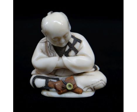 FINE JAPANESE STAINED &amp; INLAID IVORY NETSUKE, Meiji Period, of a seated man contemplating his wood, shell and stained ivo