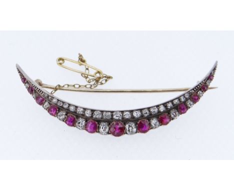 FINE DIAMOND &amp; RUBY ENCRUSTED CRESCENT BROOCH, c. 1890, the forty-eight graduated stones set in yellow and white metal, 6