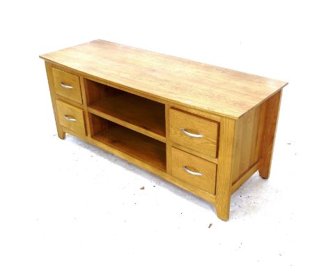 A modern light oak television stand, with open shelves and 4 short drawers, L120cm, H51cm, D45cm 