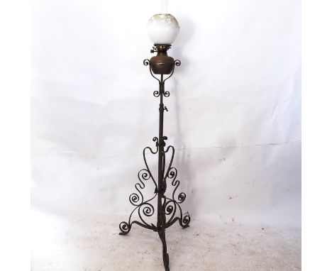 A Victorian iron telescopic oil lamp, on scrolled base 