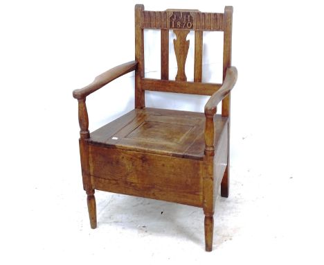 A Victorian Arts and Crafts oak commode chair, with inscription JJH 1870 