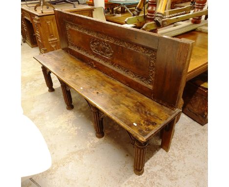 A carved and panelled oak bench, on fluted legs in Gothic style, L172cm, H99cm, seat height 50cm