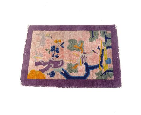 An early 20th century Art Deco purple ground tufted Oriental rug, worn, 87cm x 61cm 
