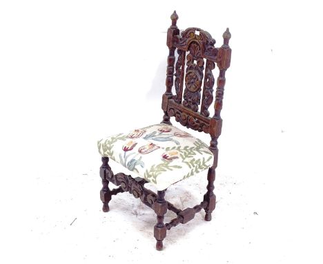 A 17th century style carved oak child's chair with tapestry seat 