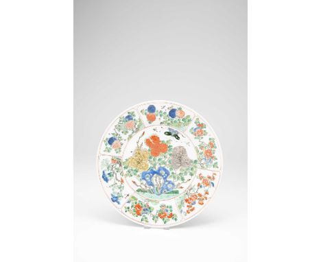 A CHINESE FAMILLE VERTE PLATEKANGXI 1662-1722Brightly enamelled with large peony blossoms and a butterfly above blue rocks, a