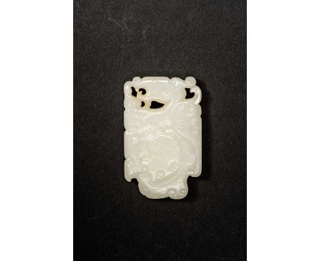 A CHINESE WHITE JADE 'DRAGON' PENDANTQING DYNASTY OR LATERCarved in relief in stylised kui dragon amidst scrolls, 5.6cm.