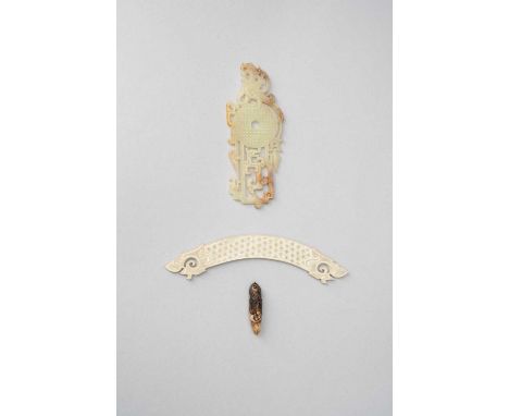 THREE CHINESE JADE ITEMSWARRING STATES PERIOD AND LATEROne a calcified jade curved pendant, huang, carved with seeds, 13cm, a