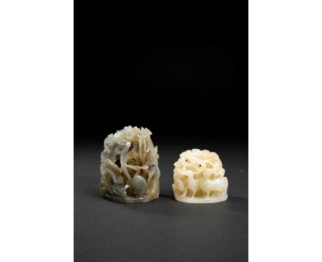 TWO CHINESE RETICULATED JADE HAT FINIALSPROBABLY QING DYNASTYThe larger in a greyish stone, carved with egrets beneath lotus 