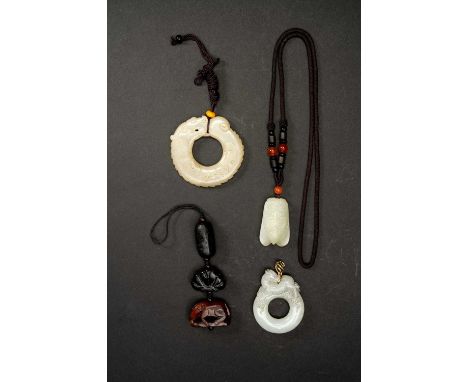 FOUR CHINESE JADE PENDANTSQING DYNASTY OR LATEROne carved as a cicada, another as a horse, one as a ring with a qilin surmoun