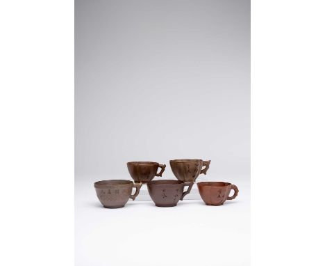 FIVE CHINESE YIXING TEA CUPS18TH CENTURYVariously shaped, each incised with a calligraphic inscription to one side and set wi