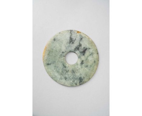 A CHINESE JADE DISC, BIPROBABLY QING DYNASTYThe pale celadon mottled stone with dark green and brown inclusions, 15cm. PLEASE