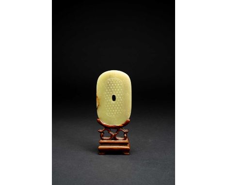 A CHINESE YELLOW JADE ARCHAISTIC OVAL PLAQUEQING DYNASTY OR LATEROne side carved with studs within a border of the bajixiang,