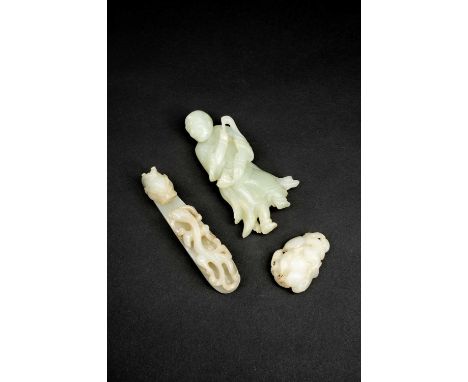 THREE CHINESE CELADON JADE ITEMSQING DYNASTYOne a figure of a sage holding a fly-whisk and a lotus stem, another a belt buckl