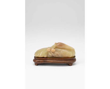 A CHINESE YELLOW JADE MODEL OF A CRANE LATE QING DYNASTY/REPUBLIC PERIODSitting with its head turned over its back, holding a