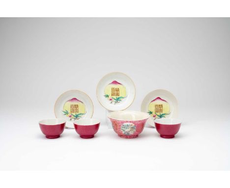 A SET OF THREE CHINESE FAMILLE ROSE RUBY-BACKED 'WAN SHOU WU JIANG' TEA BOWLS AND SAUCERS20TH CENTURYEach decorated with a la