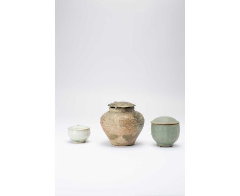 THREE CHINESE JARS AND COVERS HAN-MING DYNASTYThe largest with an iridescent green glaze, moulded with a band of animals to t
