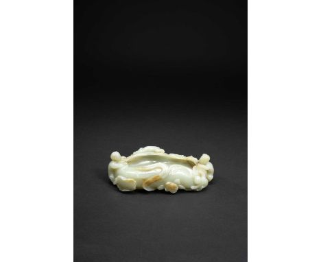 A CHINESE CELADON JADE 'BOYS' BRUSHWASHERQING DYNASTY OR LATERFormed as a large lotus leaf, supported by stems, leaves and bu